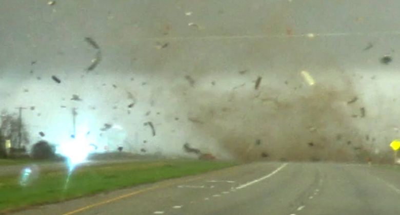 Uma caminhonete vermelha  engolida pelos ventos de um tornado em uma estrada do Texas. Apesar dos ventos violentos, a caminhonete conseguiu escapar minutos depois. Crdito: Reproduo twitter/@brianemfinger 